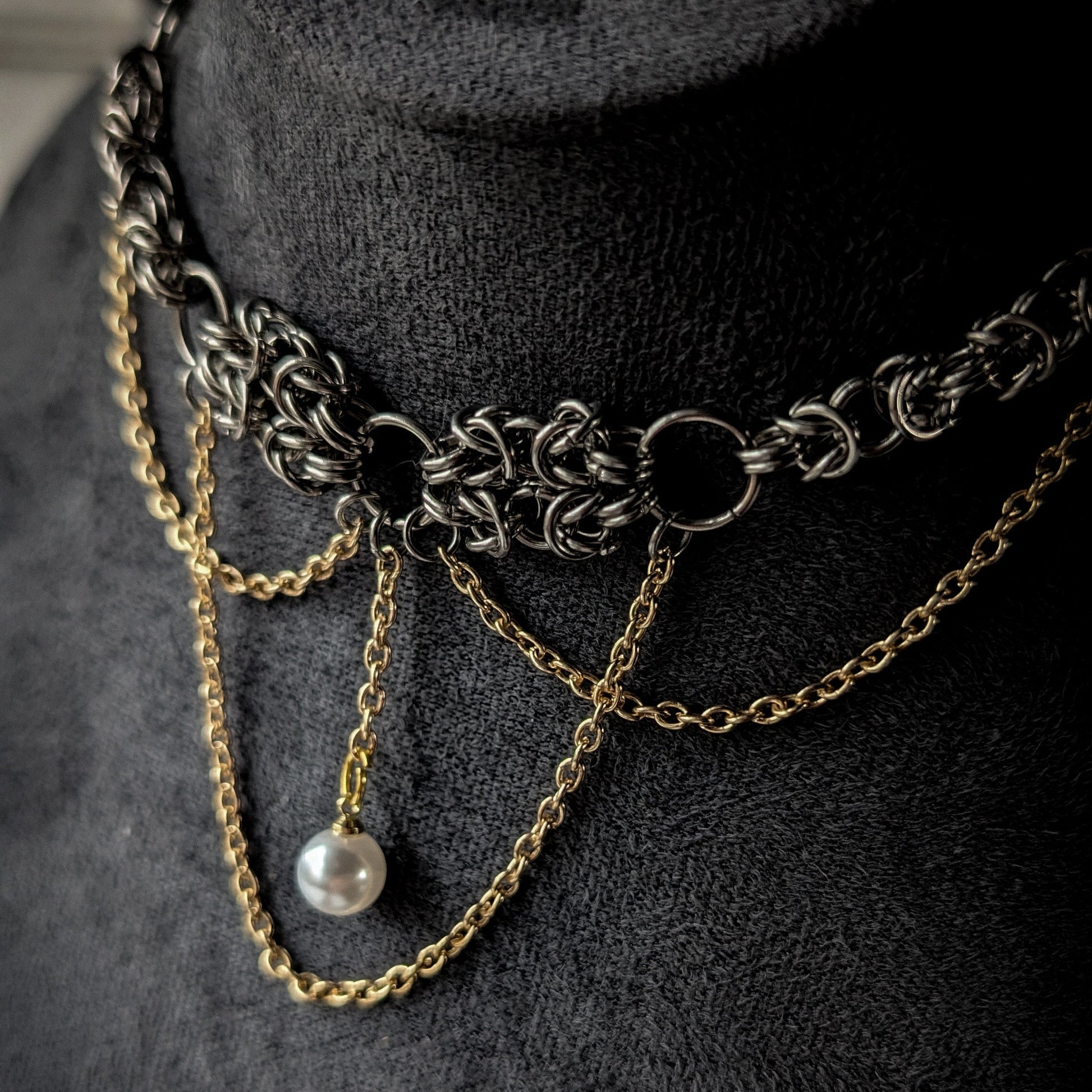 Necklace with chain and pearl on a dark background