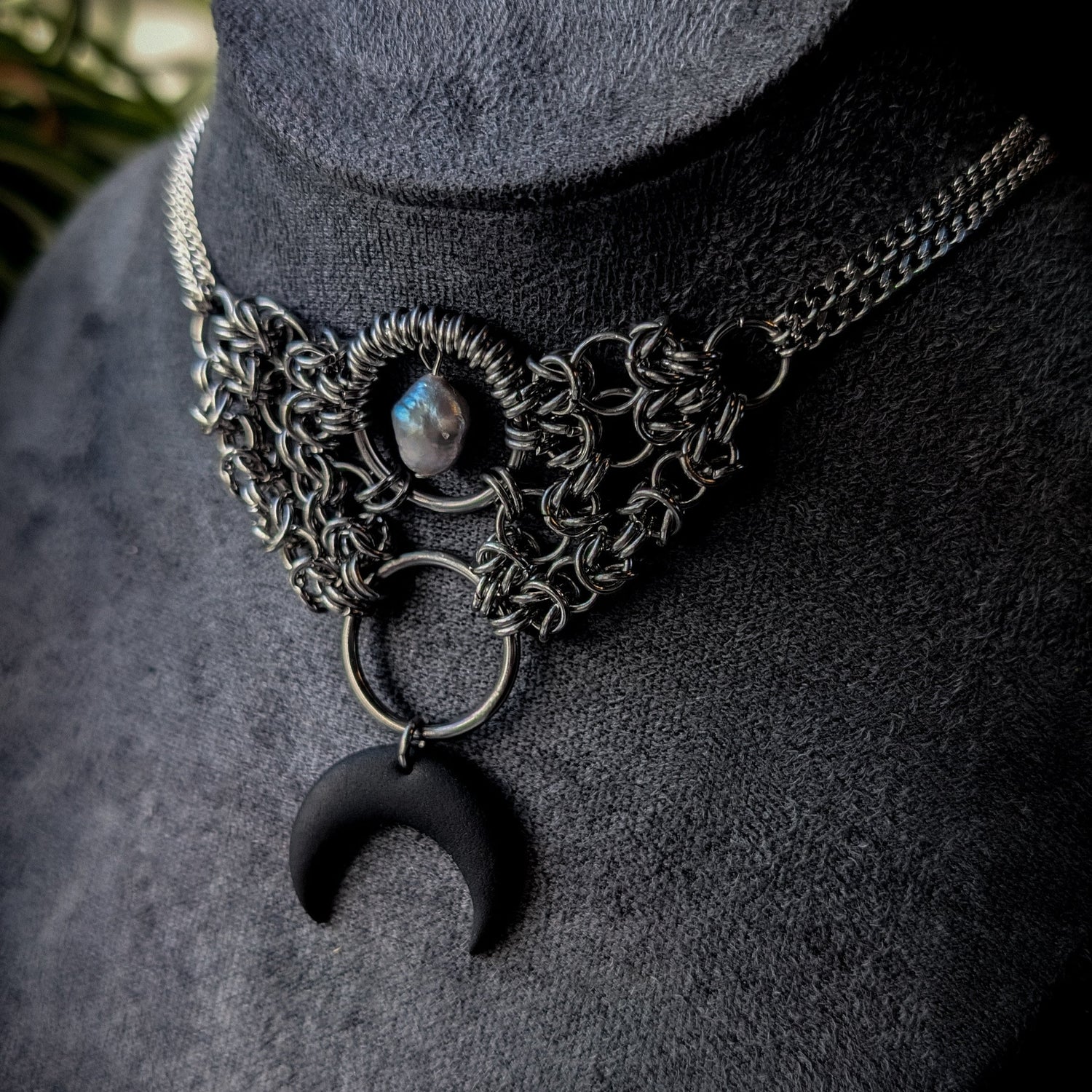Necklace with a crescent moon pendant and freshwater pearl